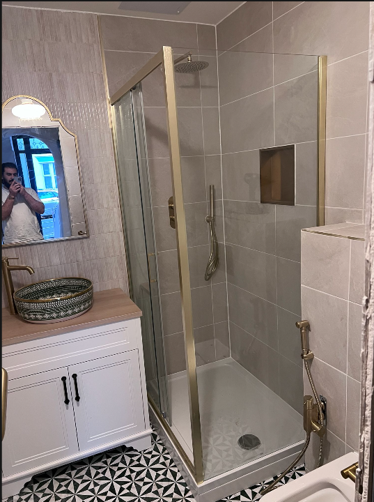 Bathroom with brushed-gold shower enclosure